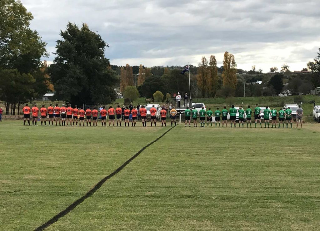 Taralga Tigers and Jindabyne Bushpigs observing a minute's silence before today's match
